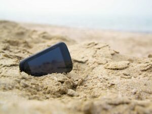 phone on a beach enjoying removal of roaming charges